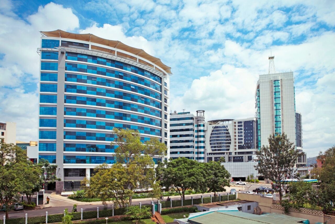 High-rises in Kigali against the backdrop of a blue sky with clouds.