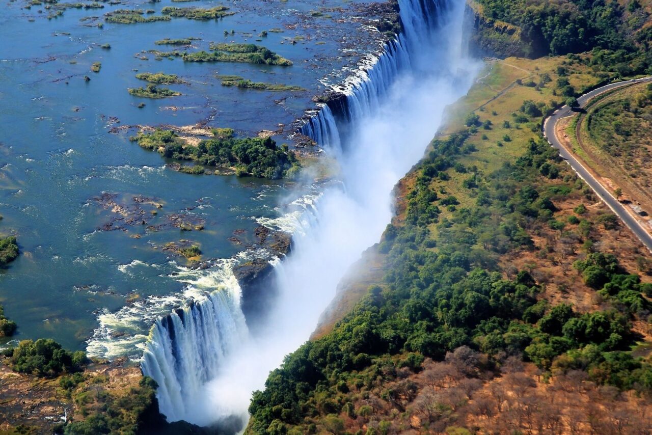 Aerial view of Victoria Falls with mist rising above the dramatic crack.